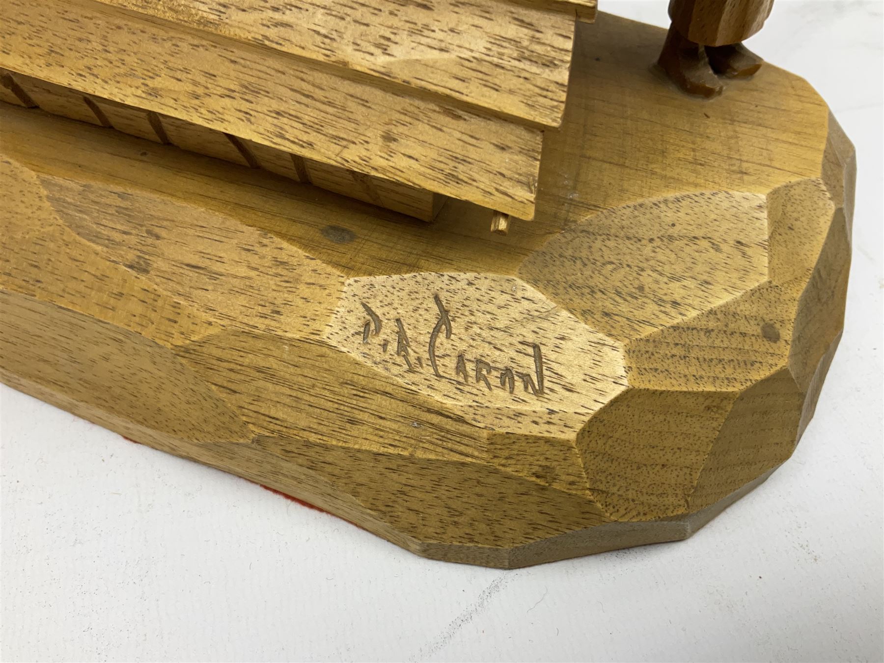 Mid 20th century Paul Caron carved table lamp, modelled as man standing before an oven, the chimney supporting the panelled shade, the base signed P.E. Caron, H42cm