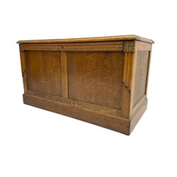 Arts and Crafts oak panelled chest or coffer, rectangular hinged lid, the uprights topped with gilt foliate carving over linenfold decoration
