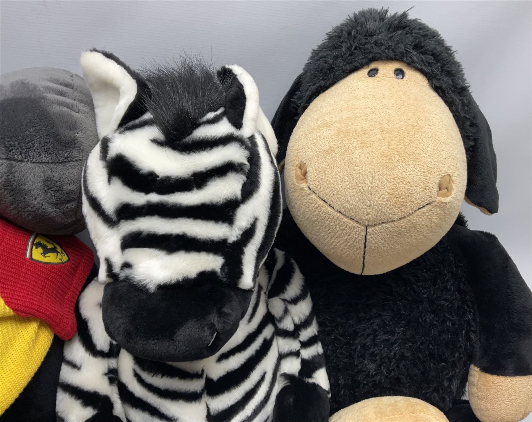 Four large Nici plush toys, comprising of two 'I love Ferrari' horses, with baseball hats, zebra and a black sheep, largest example H115cm 