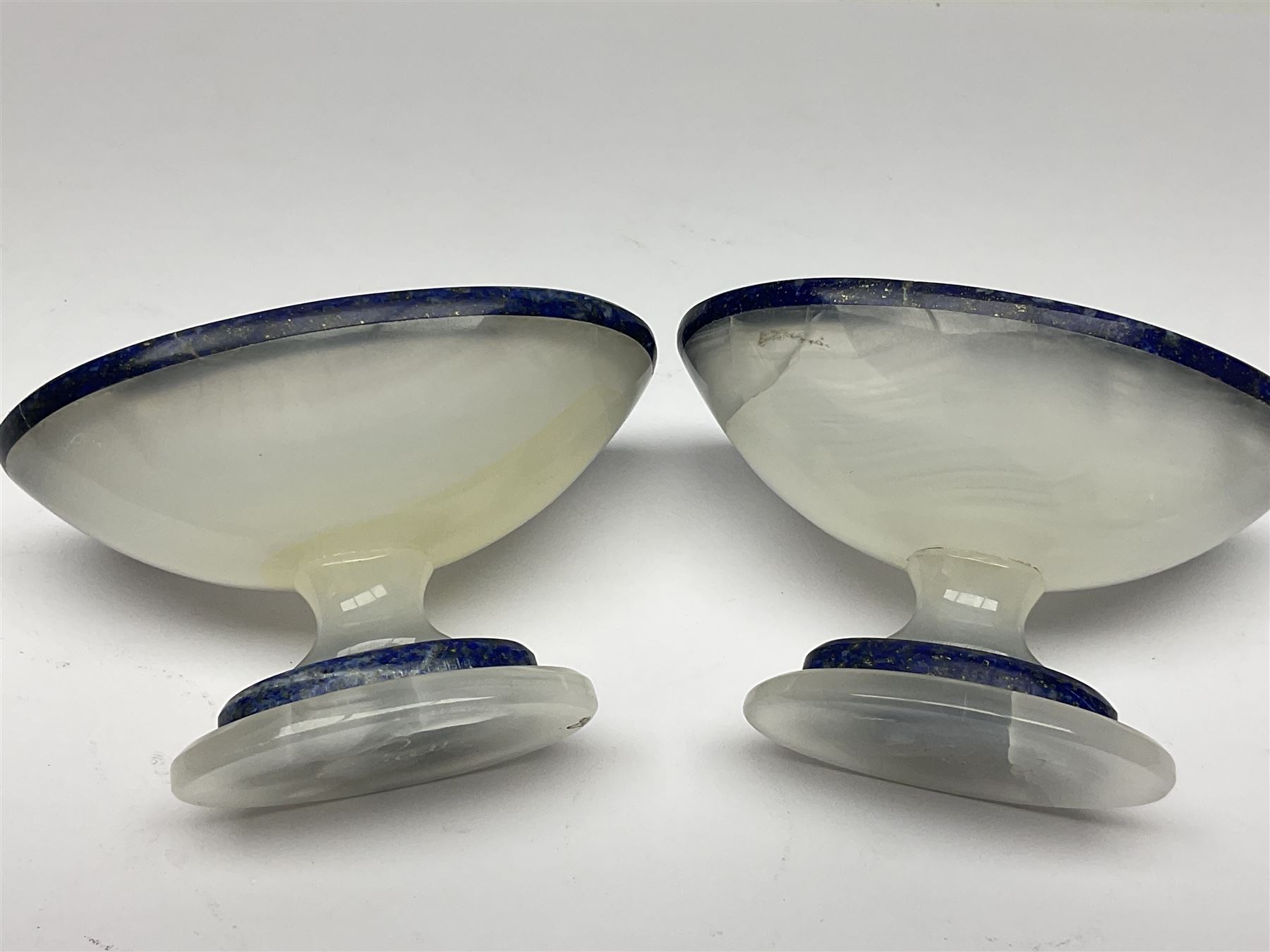 Pair of lapis lazuli and agate open salts, of navette form, upon a stepped oval pedestal foot, H5cm, L8cm