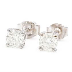 Pair of 18ct white gold diamond stud earrings, each stud set with a round brilliant cut diamond, stamped, total diamond weight approx 0.95 carat