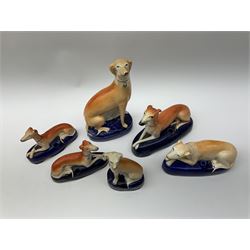 A group of Victorian Staffordshire and later figures modelled as greyhounds, to include a pair of pen stands, largest H20cm. 