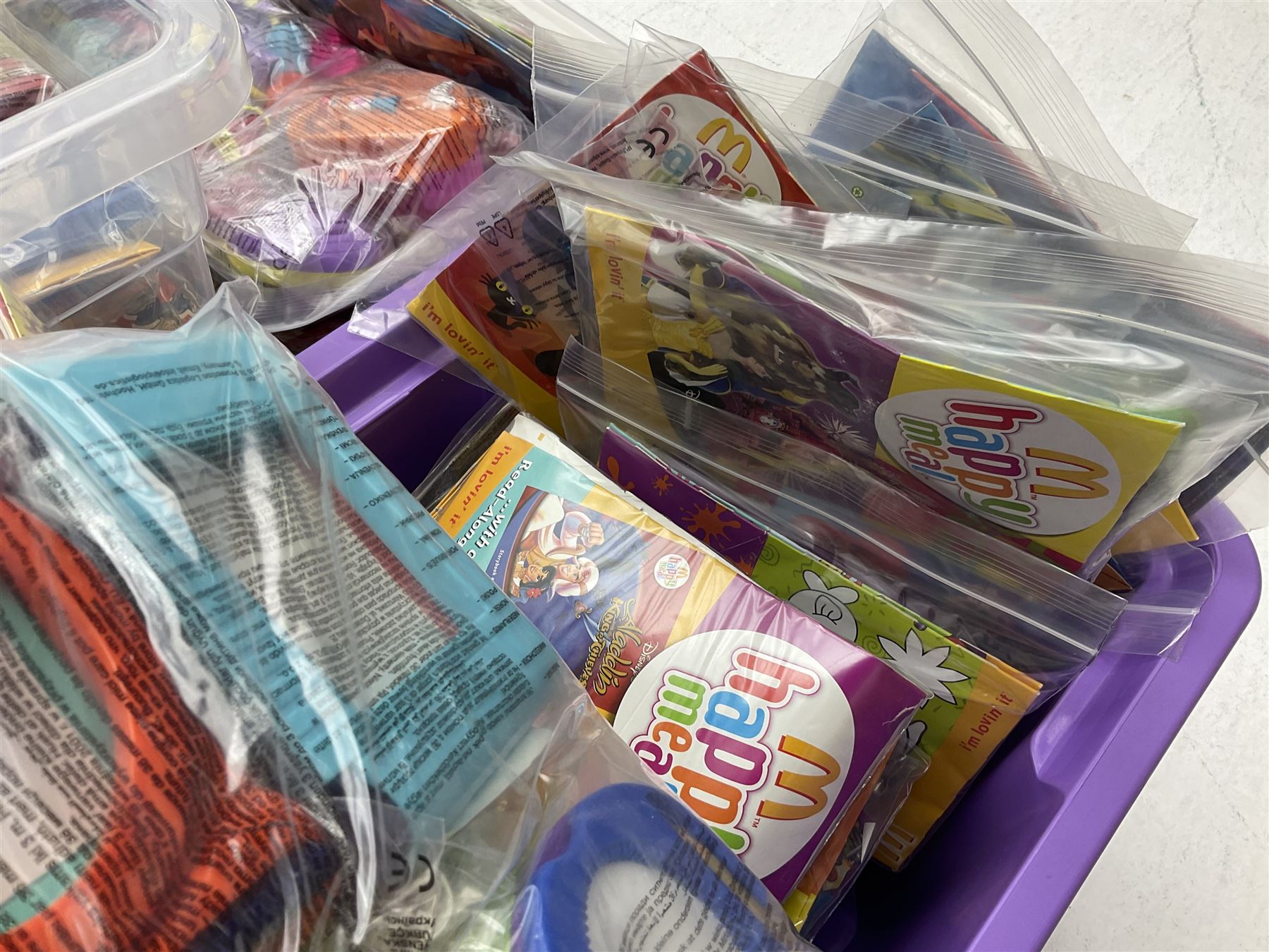 Large quantity of Mcdonalds toys to include Herbie and Polly Pocket in three boxes