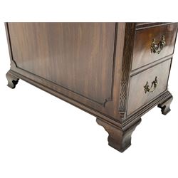 Large Georgian design mahogany twin pedestal partner's desk, moulded rectangular top with canted corners and inset leather writing surface, fitted with nine drawers and two cupboards, the pedestals with canted uprights decorated with blind fretwork, on ogee bracket feet