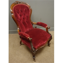  Victorian walnut framed open armchair, upholstered back seat and arms in red velvet, carved cresting rail and foliate cabriole legs, W68cm  