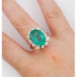 18ct gold oval cut emerald and round brilliant cut diamond cluster ring, hallmarked, emerald approx 5.80 carat, total diamond weight approx 1.00 carat