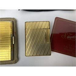 St Dupont gold plated cigarette lighter, with engine turned decoration, serial no EW1279, together with three powder compacts, including Stratton and Regent of London examples