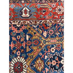 Persian blue ground carpet, the field divided up into panels by trailing bands with flower heads, each panel decorated with palmettes and stylised plant motifs, the border decorated with further palmettes, within floral pattern guard stripes 