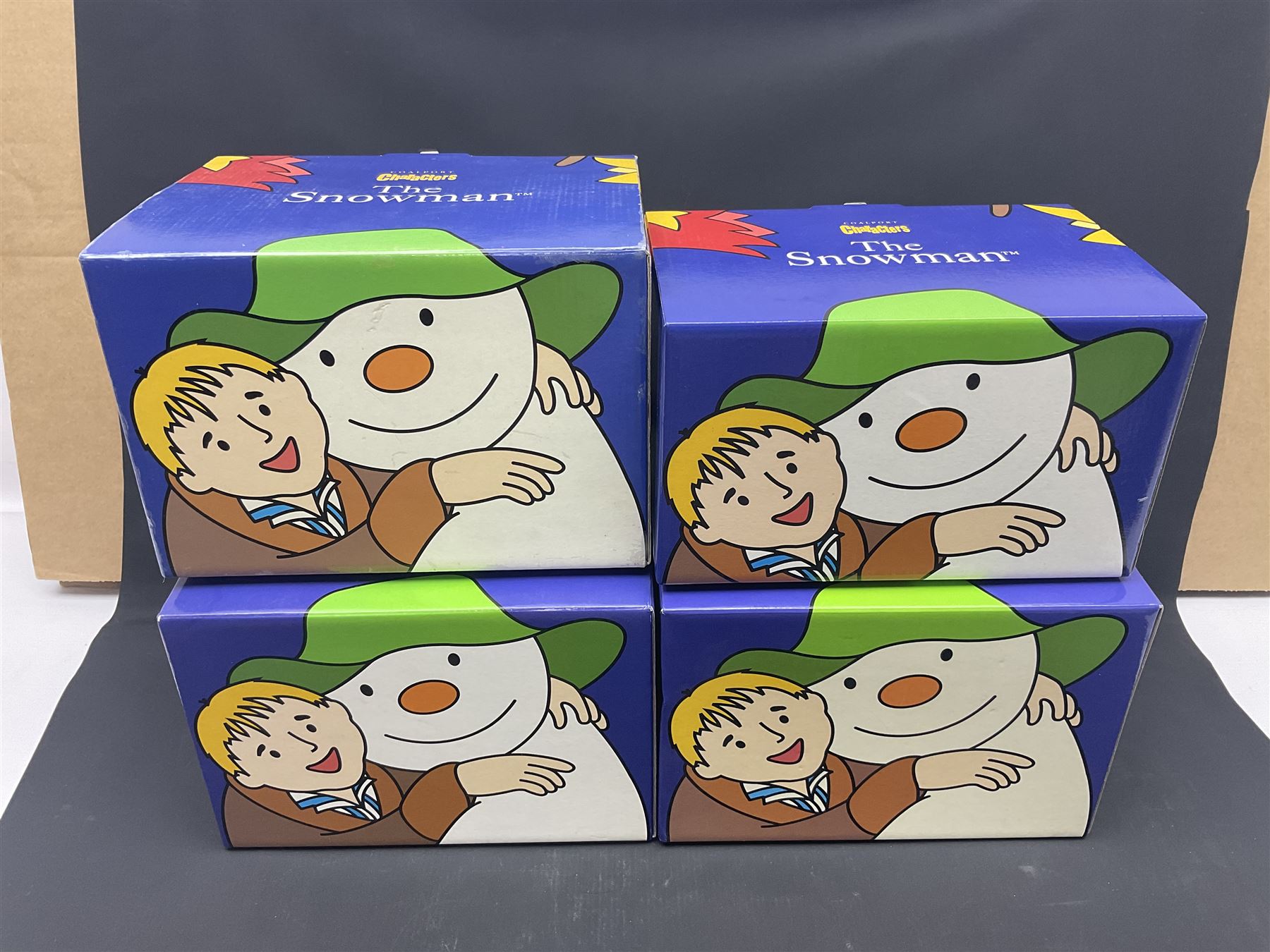 Four Coalport Characters The Snowman figures, comprising Dancing the Night Away with certificate, Penguin Pals, with certificate, Dressing Up and Soft Landing, all with original boxes 