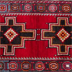 South-west Persian Lori rug, the red field centred by four linked stepped cruciform medallions with polychrome diamond centres, enclosed by a blue ground octagonal motif border, ivory angular meander band and red geometric outer border