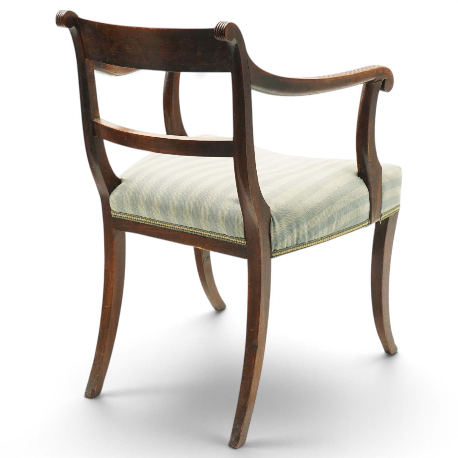 Georgian mahogany reeded carver armchair or elbow chair, bar back and scrolled arm terminals above over-stuffed seat, raised on sabre supports