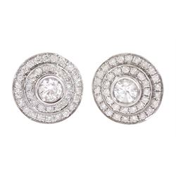 Pair of 18ct white gold round brilliant cut diamond halo stud earrings, the central bezel set diamonds with two row diamond surround, stamped, total diamond weight approx 1.20 carat