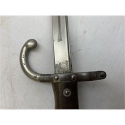 French Model 1866 Chassepot bayonet with 57cm curving fullered steel blade dated 1873 No.L63963; in steel scabbard with conforming number L71.5cm overall; and French St. Etienne Gras bayonet dated 1878 No.K10674 in steel scabbard numbered 79437 (2)