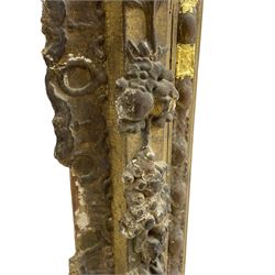 19th century giltwood and gesso moulded picture or mirror frame, the arched cresting rail mounted by central cartouche decorated with foliate scrolls and fruit, the outer frame decorated with scalloped edge and shell mouldings, trailing foliage with flower head and fruit to the central band, egg and dart moulded inner slip
