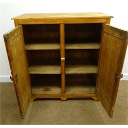  Early 20th century pitch pine cabinet, two panelled doors enclosing fitted interior, shaped apron, W99cm, H106cm, D47cm  