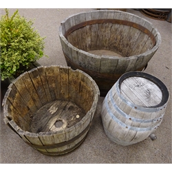  Large oak and metal bound half barrel planter (D94cm, H57cm), another small half barrel planter and a small barrel  