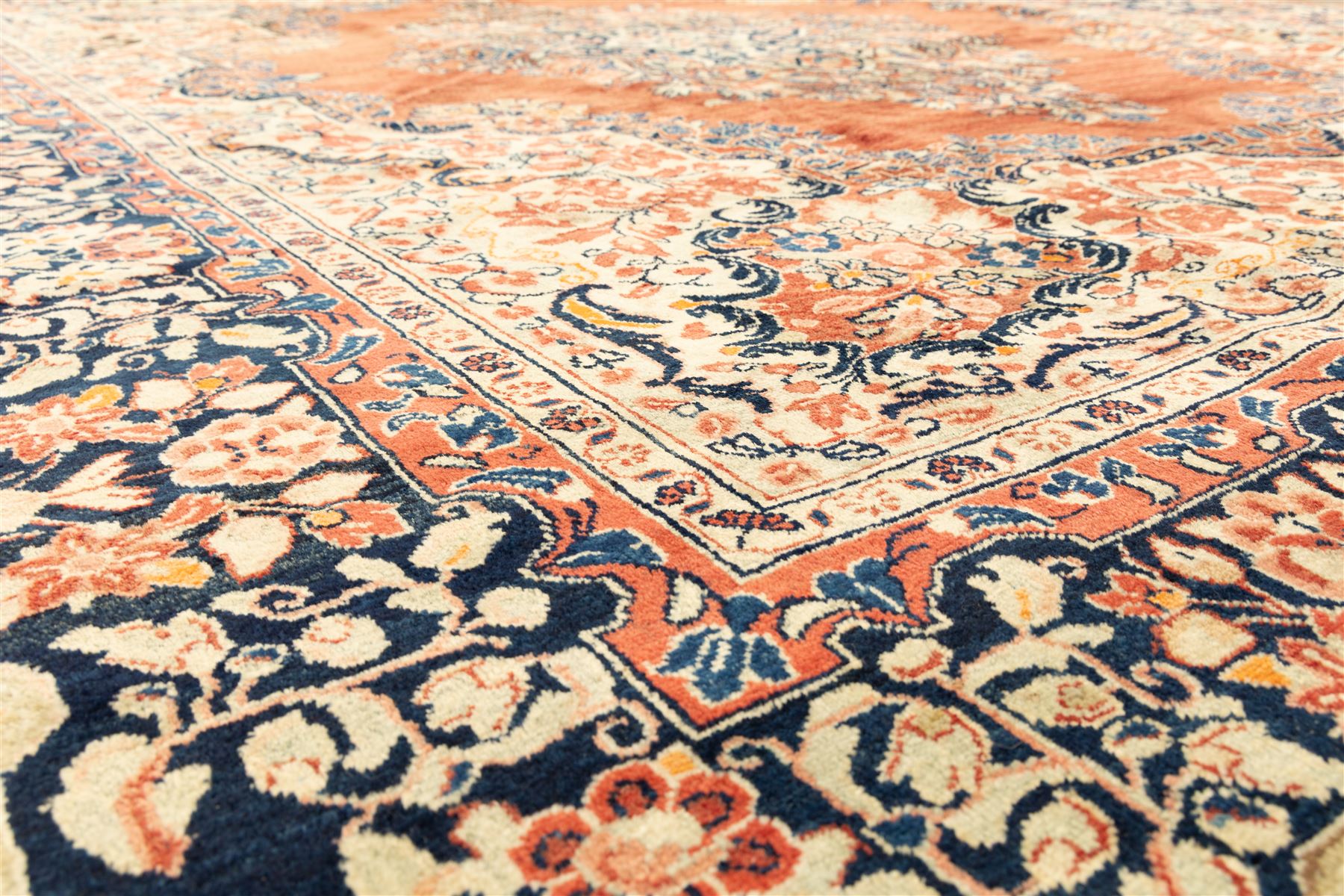 West-Central Persian Mahal hand-knotted carpet, terracotta field with a large central indigo and ivory medallion with floral palmettes and scrolling vines, framed by ivory spandrels with dense foliage within a broad navy border of lotus and palmette motifs linked by scrolling tendrils and multiple guard stripes 