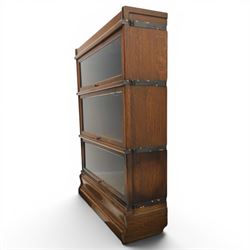 Globe Wernicke - early 20th century oak stacking bookcase, three tiers, lift up glazed doors raised on a plinth base