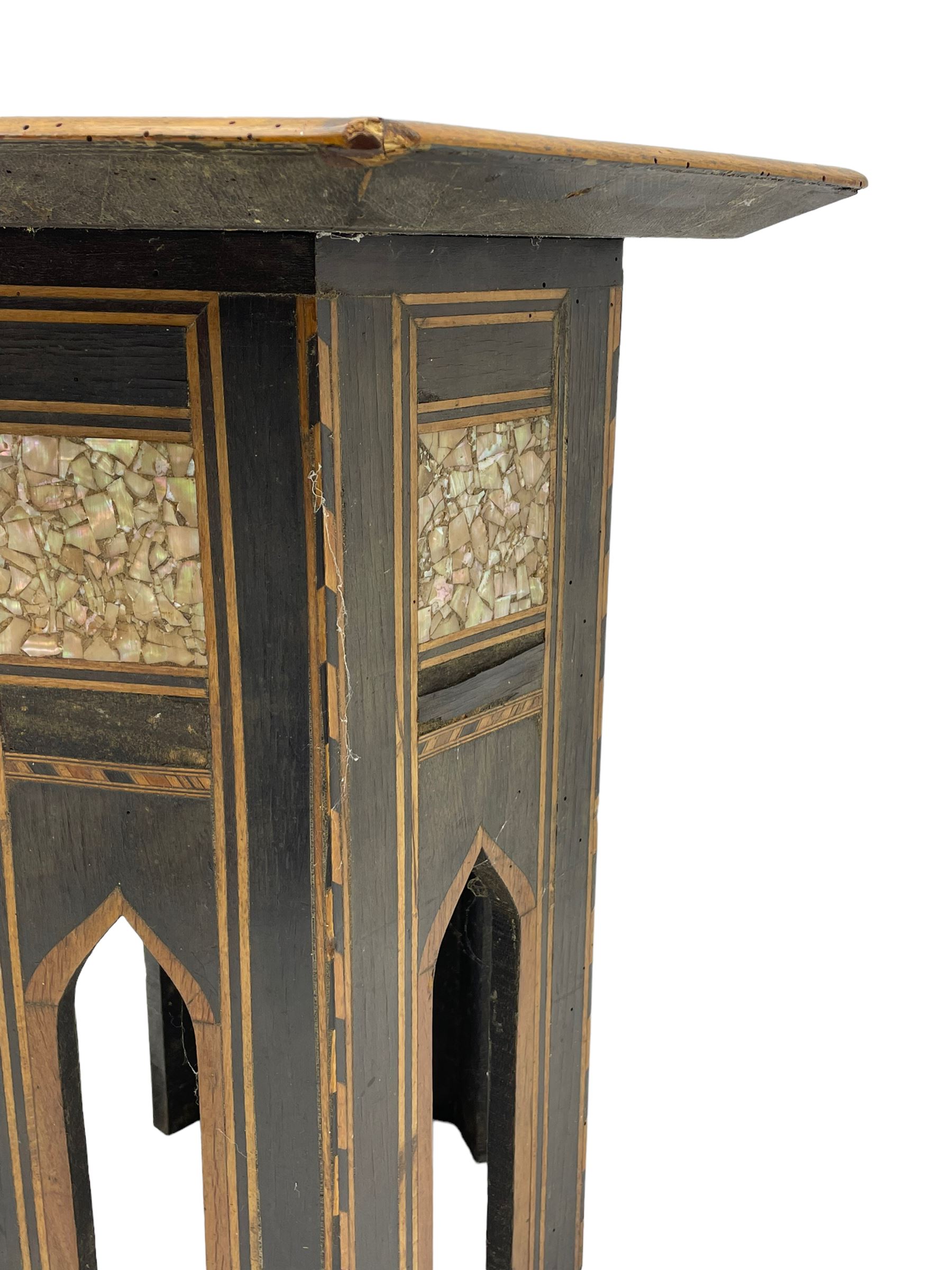 Early 20th century Anglo-Indian hexagonal table, the top decorated with mother of pearl beads and chequered banding, the base with fretwork pointed arches and inlays