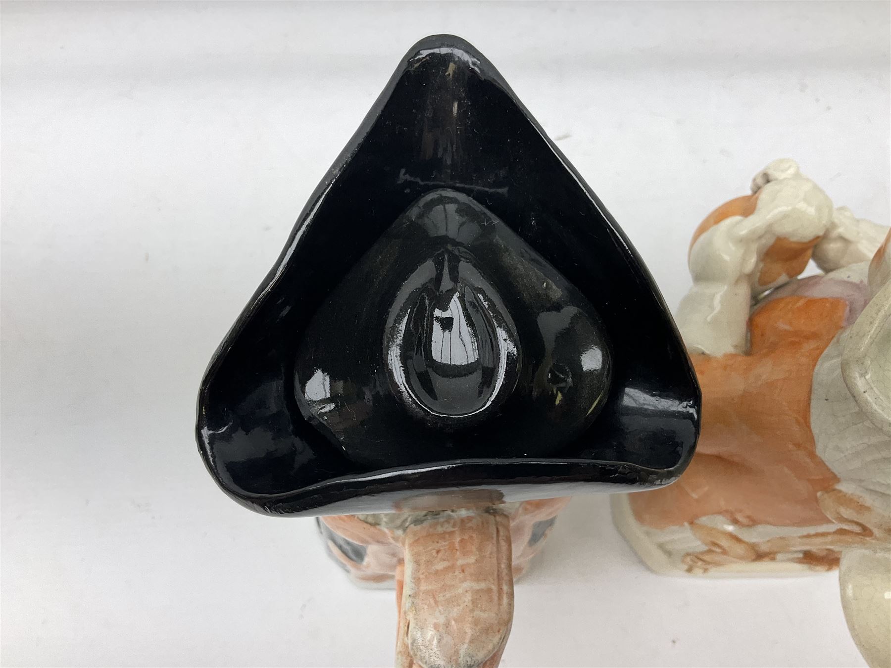 19th century and later Toby jugs comprising Staffordshire Punch and Judy jugs, Victorian 'I am on the black list' jug, two jugs in the form of Toby with a jug of beer (5)