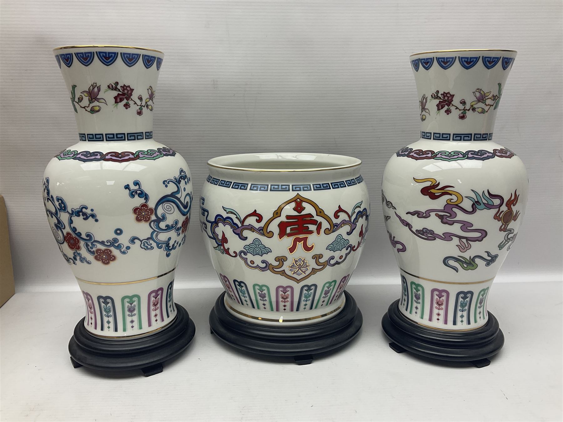 Franklin Mint Chinese style ceramics, comprising two vases, puppy and a planter, all on wooden stands