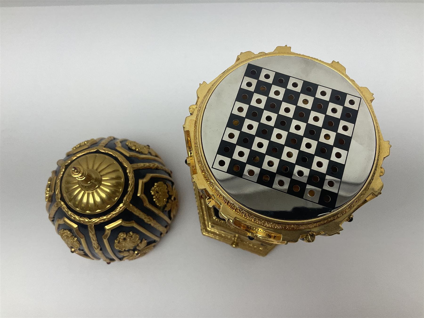 Franklin Mint House of Faberge; The Imperial Jeweled Egg Chess set, the egg opening to reveal a chess board, with a draw to the hexagonal base holding the miniature chess pieces, H23cm 
