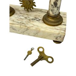 20th century French portico clock c1910 on a white veined marble base, gilt drum movement case supported between two marble columns with brass capitals and a suspended garland swag with a starburst pendulum beneath, enamel dial with Arabic numerals, floral decoration and Louis XV pierced gilt hands, convex glass and brass bezel, 8-day countwheel striking movement striking the hours and half hours on a bell. 




