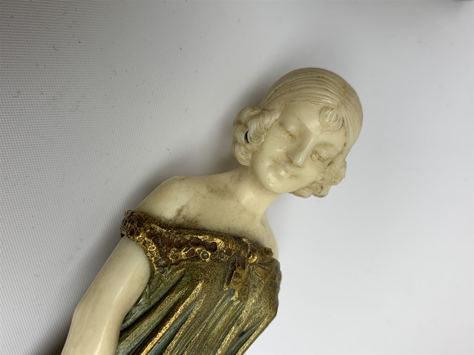 Demetre Chiparus (1886-1947): Innocence, a gilt bronze and ivory figure, circa 1925, standing in contemplative post with hands clasped, upon onyx plinth, signed to base, H24.4cm