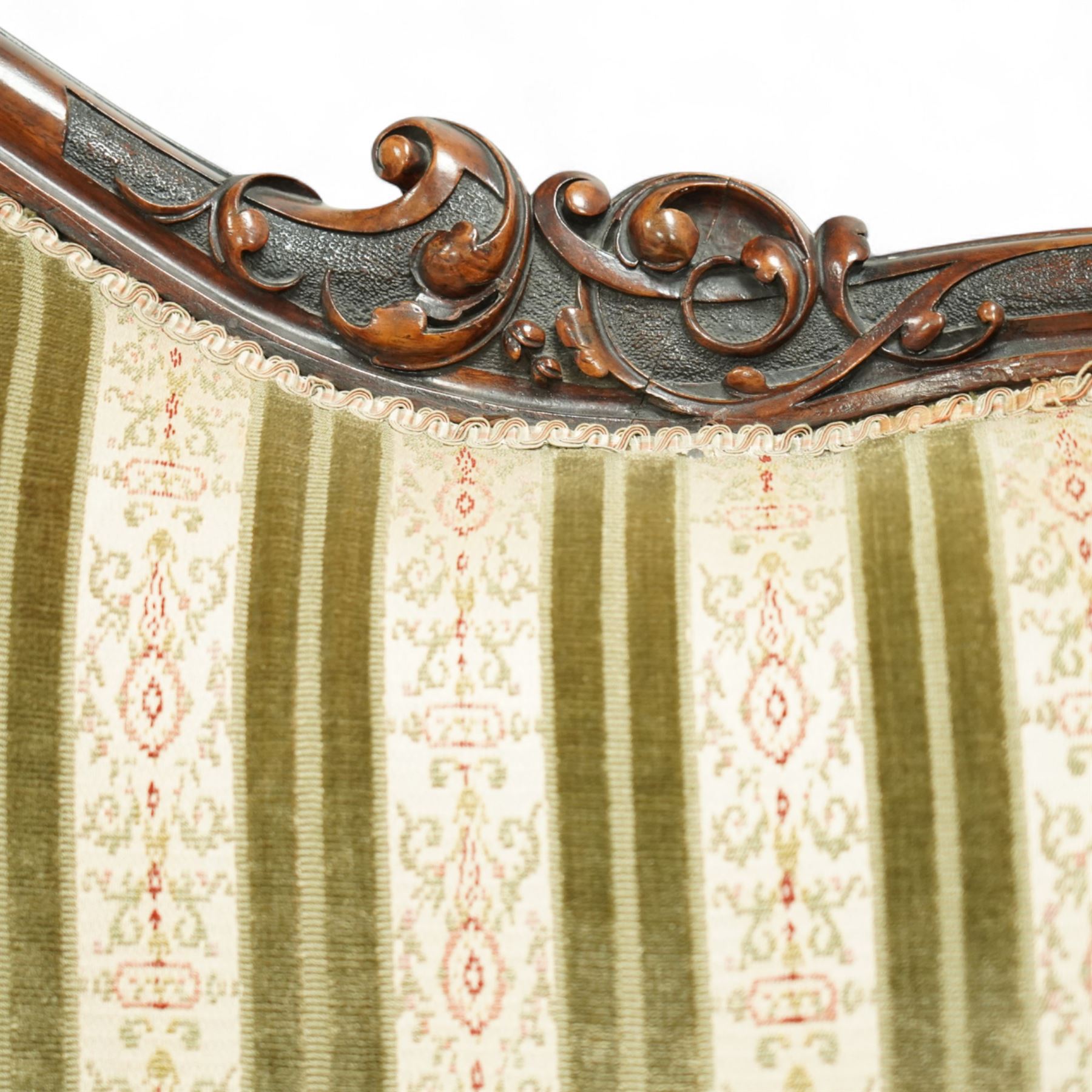 Victorian walnut framed salon sofa, the shaped back and scroll arms with carved floral detail, upholstered in green and cream striped fabric, raised on scrolled cabriole legs 