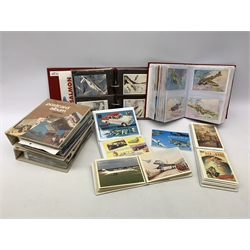 Seven modern albums containing over six hundred postcards and ephemera of aeronautical interest including real photographic and printed WW2, military and commercial aircraft, reproduction posters, Concorde (30), greeting cards, large scale etc. From the collection of the late Leslie Benson.