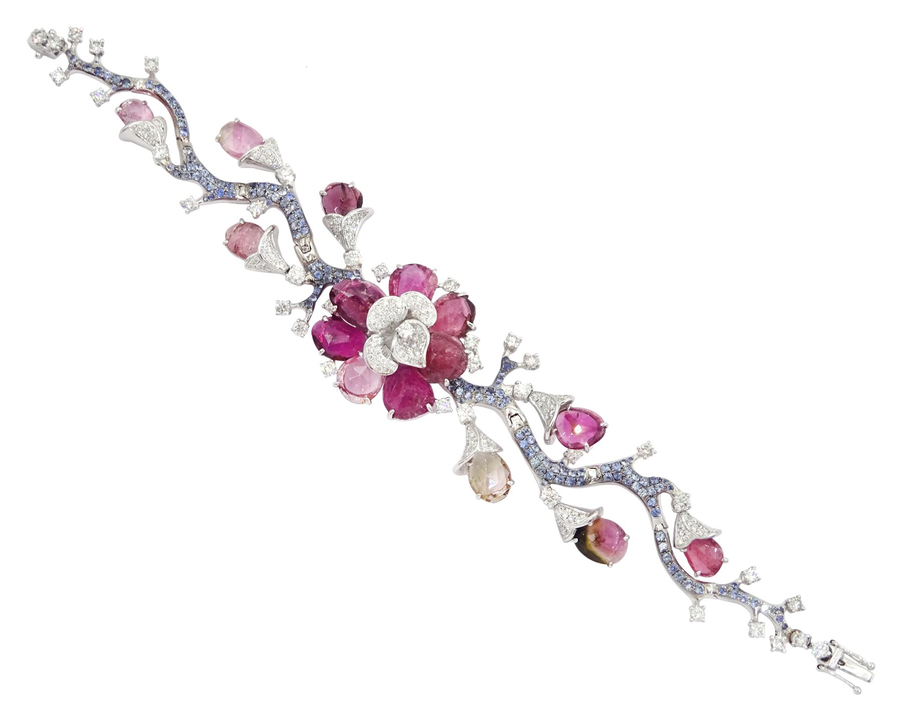 18ct white gold gemstone set floral jewellery suite, comprising necklace, pair of earrings and bracelet, each with tourmaline flower petals, round brilliant cut diamond centres and sapphire stems, stamped