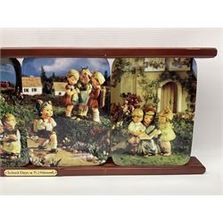 Two ceramic Hummel postcards by Goebel, both displayed on wooden easels, together nine Hummel eggs, set of four Hummel School Days plates, on wooden hanging rack, Goebel Collectors Club Member plaque etc