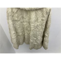 Brown mid length musquash fur coat by National Fur Company together with white rabbit cape