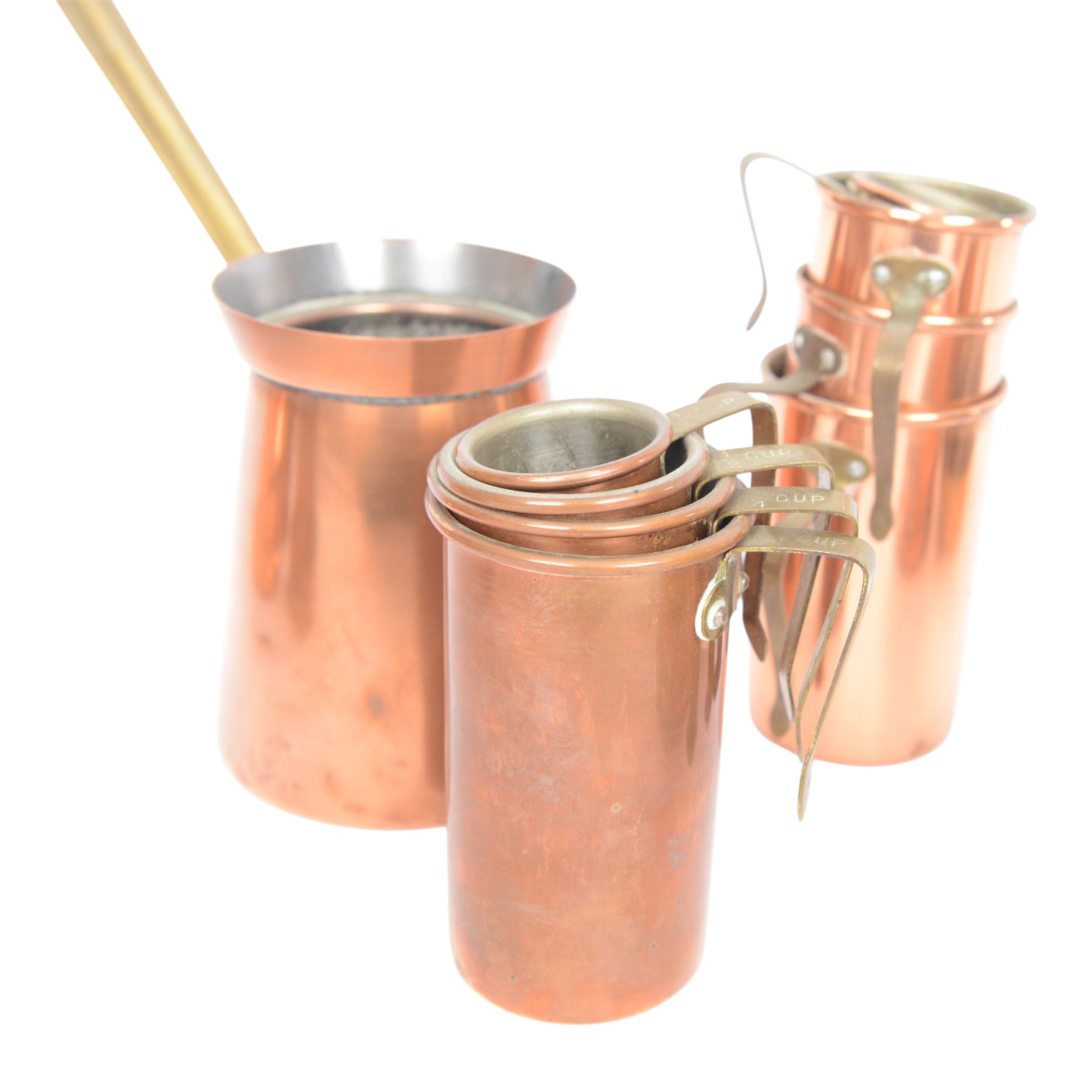 Copper and brass measures, including set of three copper jugs, set of four graduating brass pans and two sets of copper and brass cup measures
