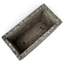 Two weathered composite stone garden trough planters, comprising a low serpentine trough relief moulded with rocaille, shell and foliate ornament (W55cm D32cm H19cm); the plain rectangular trough decorated with four moulded Yorkshire rose medallions to each side (W51cm D26cm H25cm)