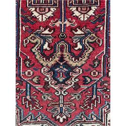 Persian Heriz red ground rug, large medallion decorated with palmettes and Ejder motifs, the border decorated with stylised plant motifs, within floral design guard stripes 