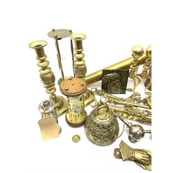 A group of assorted metalware, to include brass fire accessories, brass crumb tray and brush, set of three copper measures with brass handles, brass spirit kettle with burner stand, brass rolling pin, pair of knopped brass candlesticks, etc.  