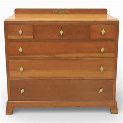 Early 20th century Art Deco bedroom suite, comprising double wardrobe, dressing table and chest of drawers, constructed in walnut with figured veneers and geometric banding, the wardrobe with arched top and panelled doors enclosing a fitted interior, the dressing table with rectangular top below a three panel mirror arrangement, fitted with two short over two long drawers, the chest with three short and three long drawers, each piece fitted with faceted handles and raised on shaped feet
Wardrobe (H 177cm, D 46cm, W 112cm)
Chest (H 85cm, D 48cm, W 92cm)
Dressing table (H 160cm, D 52cm, W 106cm)
