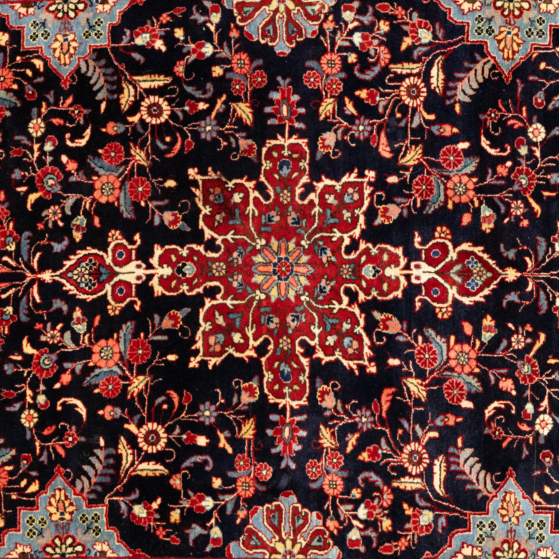 Two hand-knotted rugs, comprising Persian floral rug, dark blue ground decorated with scrolling foliage and flowerheads within a red floral border (H 208cm, W 134cm); Bokhara type rug, red ground with repeating gul motifs and geometric guard borders (H 174cm, W 94cm)