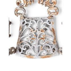 Pair of Victorian cast iron garden chairs, the ornate pierced back of scrolling foliate design, scrolling arm terminals over splayed supports formed of C and S-scrolls, in distressed white painted finish