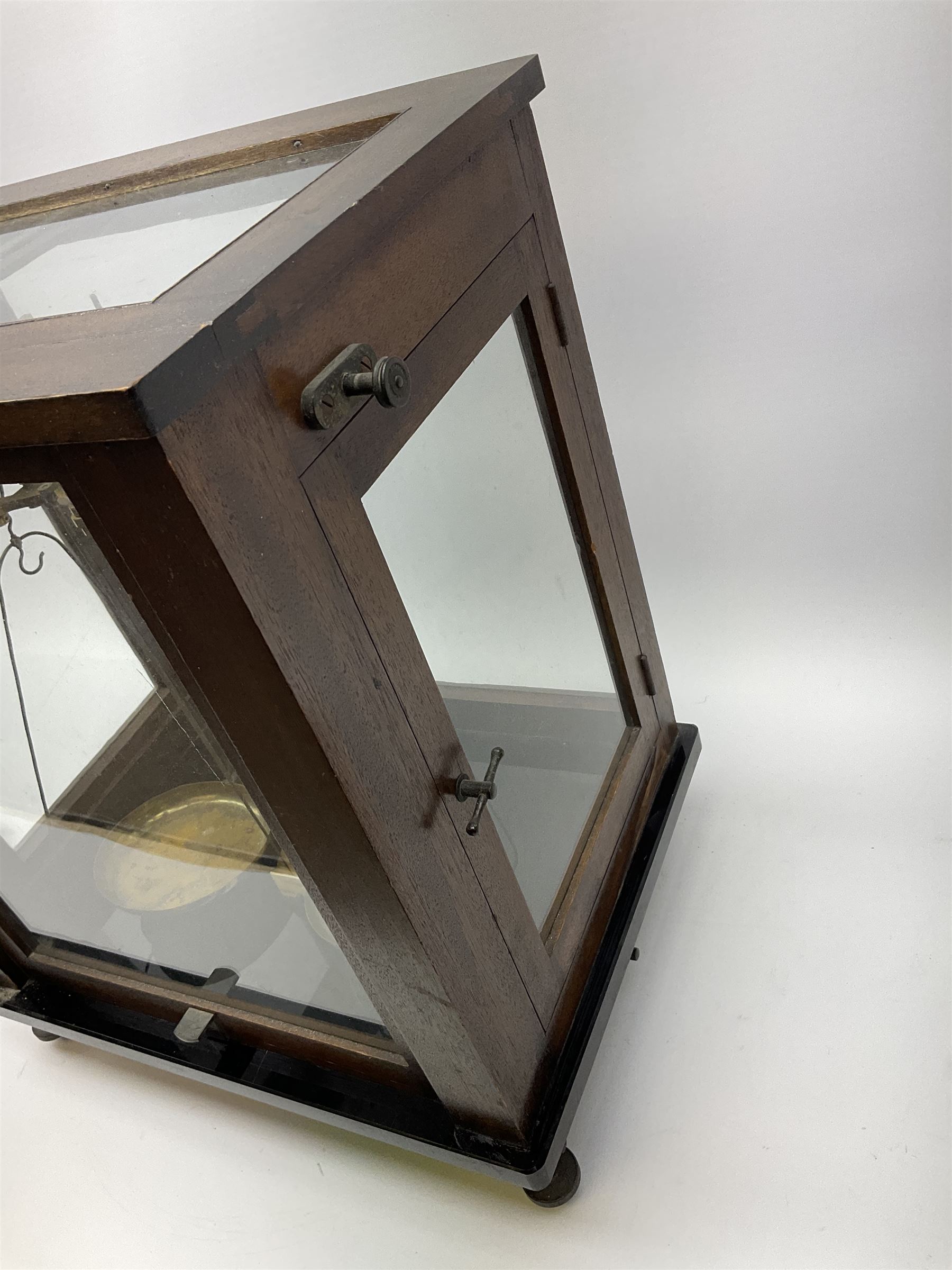 Set of laboratory balance scales by Paul Bunge Hamburg Model 9A No.7977 bearing label for Reynolds & Branson Leeds in mahogany case with upward sliding front door, two hinged side doors, hand cranked rise-and-fall facility and black vitrolite base L36cm H42cm D26cm; and two boxed part sets of weights (3)