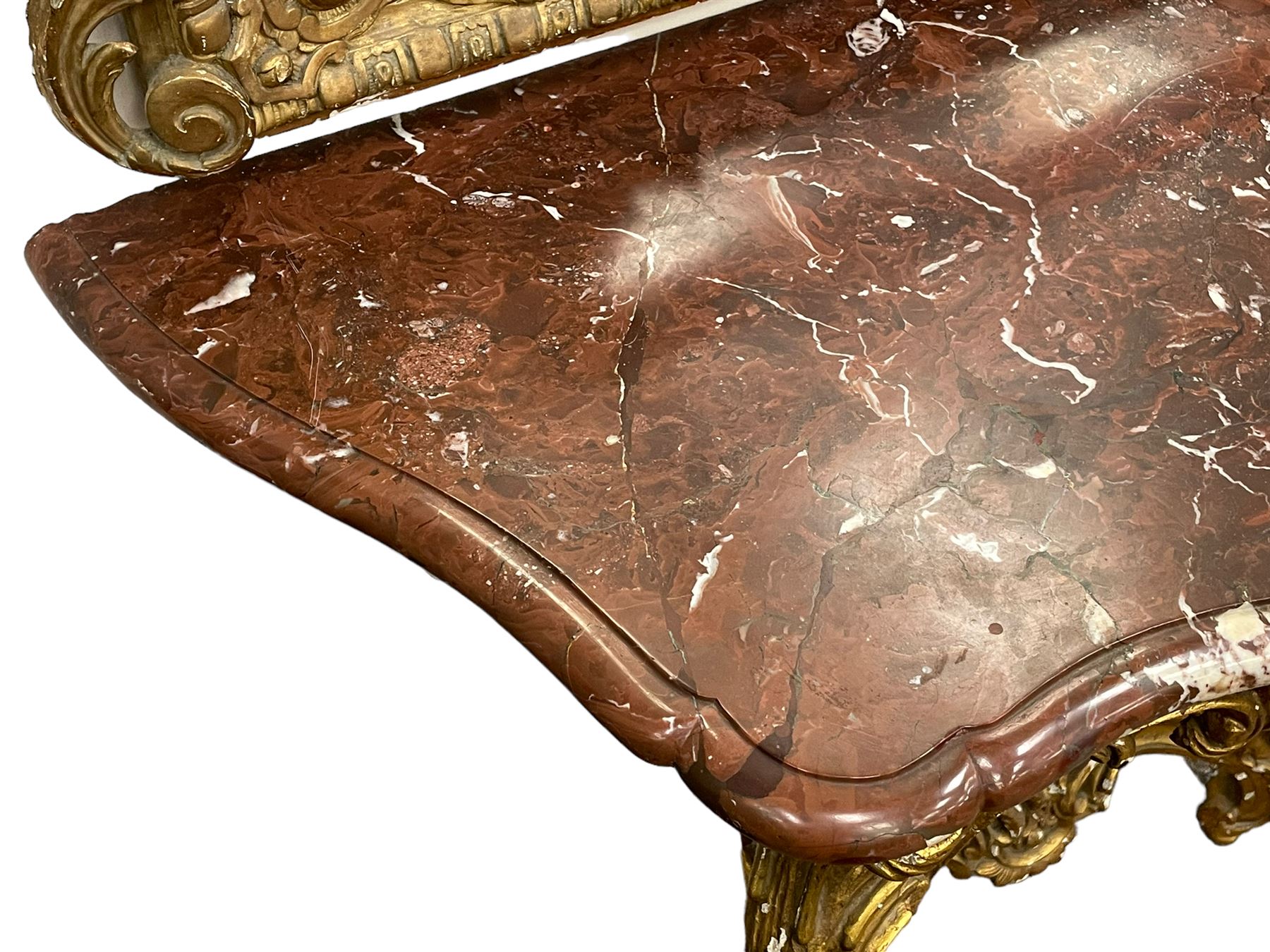19th century giltwood and gesso console table, shaped variegated rouge marble top with moulded edge, central shell motif with extending scrolled foliage, on foliate and flower head moulded cabriole supports united by pierced shell middle rail, scrolled acanthus leaf terminals 