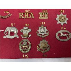 Forty glengarry and cap badges and shoulder titles including Gordon Highlanders, Canada and Canadian Field Artillery, New Zealand Field Artillery and Rifle Regiment, Shropshire Light Infantry, 14th/20th Kings Hussars, 17th Lancers, Northamptonshire Yeomanry, Royal Lincolnshire, Special Air Service, 19th Alexandra P.W.O. Hussars etc; mounted on two boards for display (2)