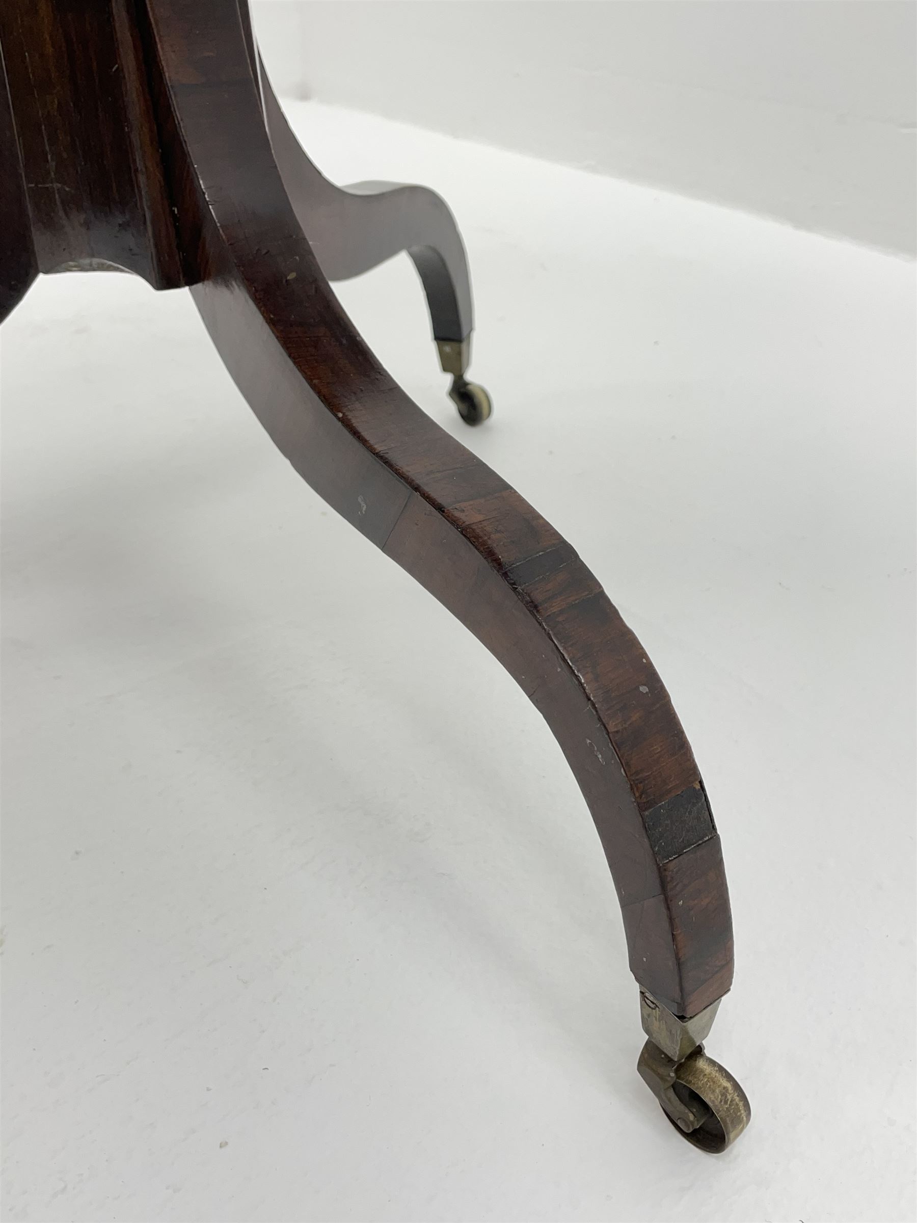 Regency style birdseye maple and rosewood tripod table, hexagonal tilt top with segmented veneer and banding, tapered hexagonal column on three splayed serpentine supports, brass cups and castors 