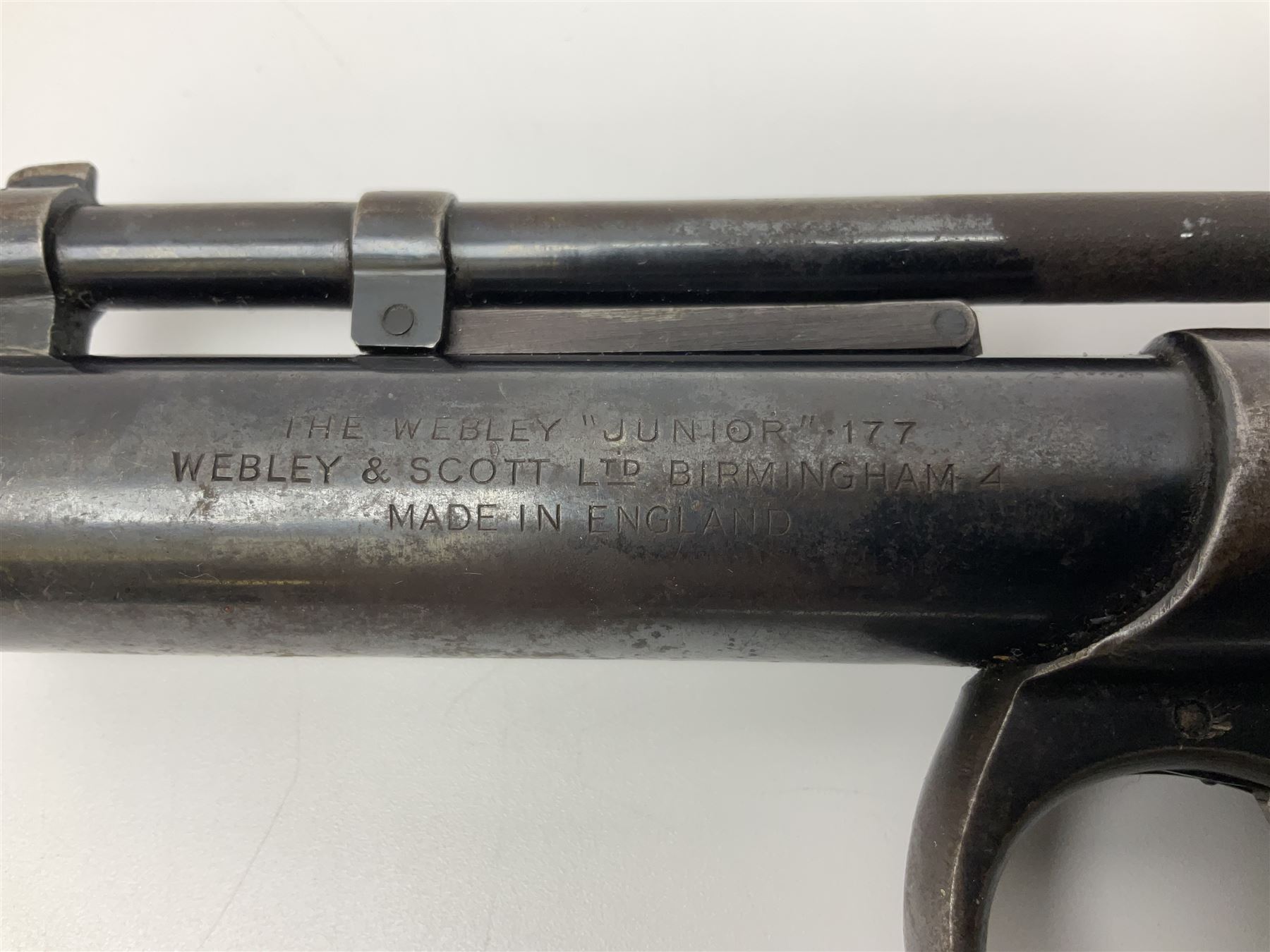 Webley 'Junior' .177 air pistol with top lever action and wooden grips; marked The Webley Junior .177 Webley & Scott Ltd Birmingham 4 Made in England to left side of cylinder; numbered 078 to muzzle and J3007 to trigger guard; L21cm; together with part tin of Webley .177 Special Pellets NB: AGE RESTRICTIONS APPLY TO THE PURCHASE OF THIS LOT.