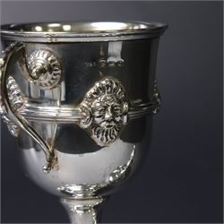 Mid 20th century silver twin handled trophy cup and cover, the bowl with central mask mounted girdle upon a knopped stem and spreading circular foot with flower head mounted paw feet, the tapering stepped cover with leaf moulded knop finial, hallmarked Vaughton & Sons, Birmingham 1938