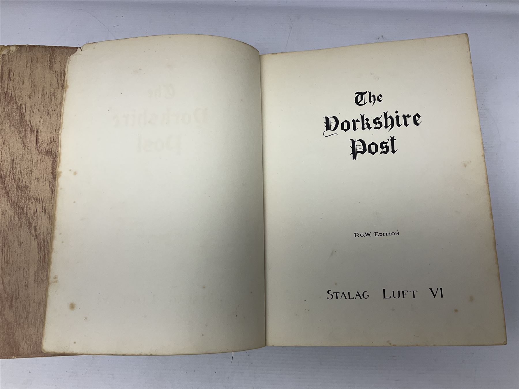 The Yorkshire Post Kriegie Edition. A 1945 book reproducing the exploits of Prisoners of War in Stalag Luft VI, with compliments letter from the publishers. Simulated wood paper covered card boards.
