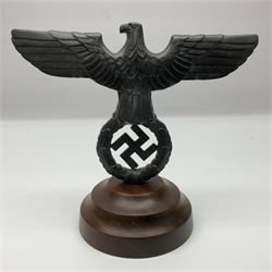 WW2 German cast white metal desk ornament/paperweight as the eagle insignia on later turned mahogany plinth H22cm