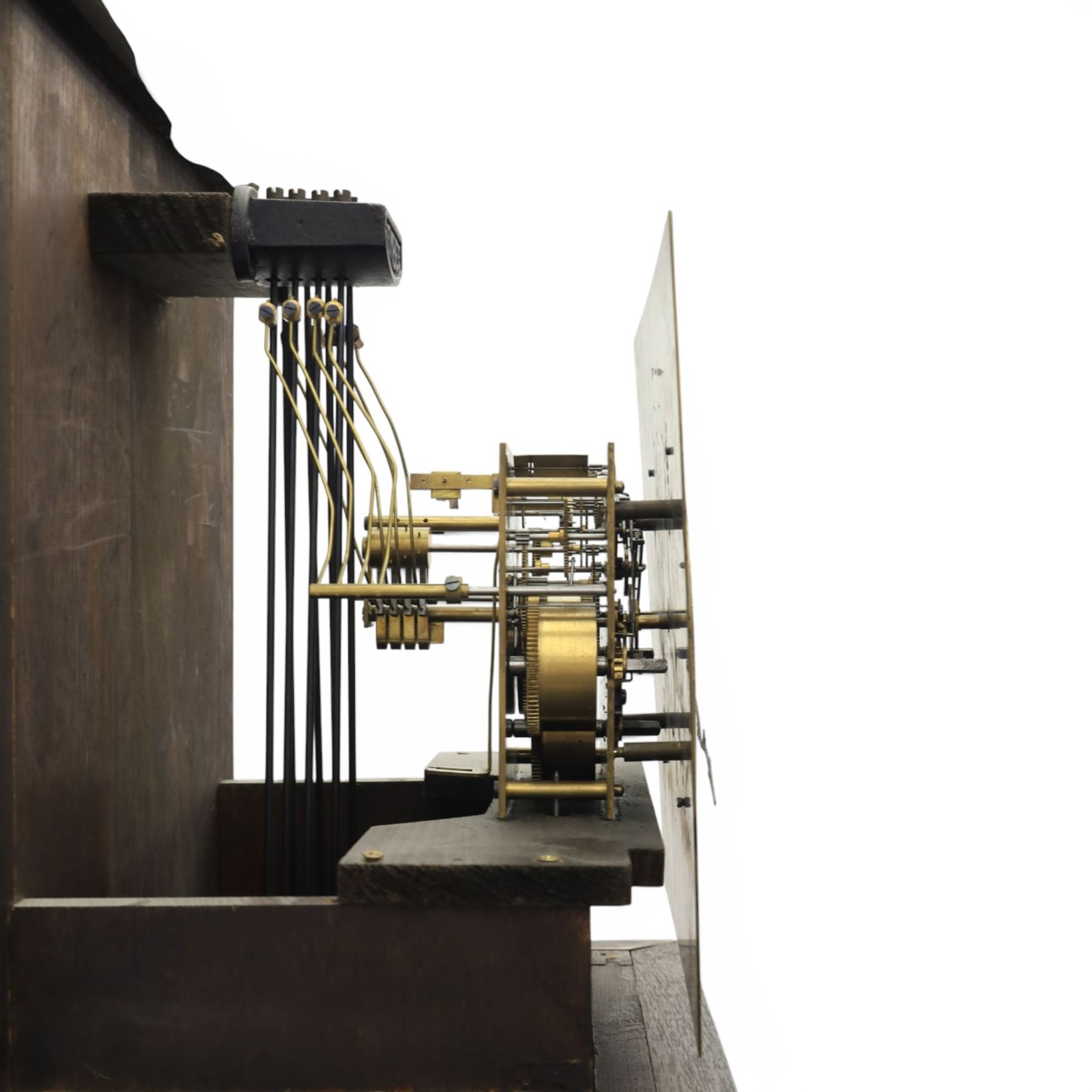 Early 20th century oak longcase clock, square brass dial with engraved foliate spandrels and centre, silvered Roman chapter ring with Arabic minute track, Westminster chime movement, the plain case with glazed arched trunk door and moulded plinth