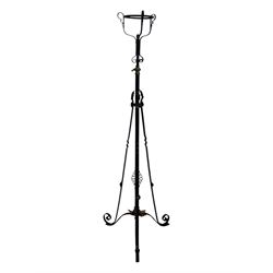 Late 19th century wrought iron and brass pulpit lamp, featuring an adjustable stem with a spiral twist detail, brass foliate mounts, and a tripod base with scrolled feet and decorative floral accents